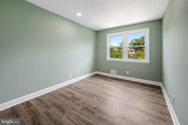 empty room featuring baseboards and wood finished floors