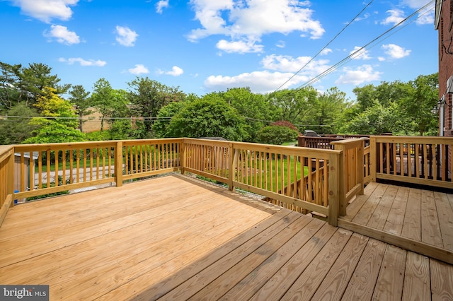 wooden terrace with view of wooded area