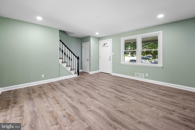 entrance foyer with stairs, wood finished floors, baseboards, and recessed lighting
