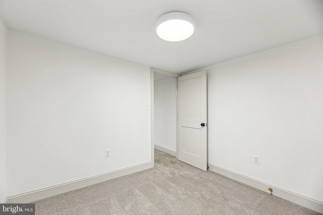 unfurnished room featuring light carpet