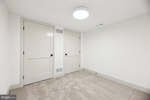 unfurnished bedroom featuring carpet floors and baseboards