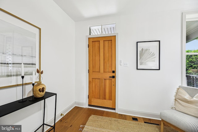 foyer featuring dark wood-style floors and baseboards