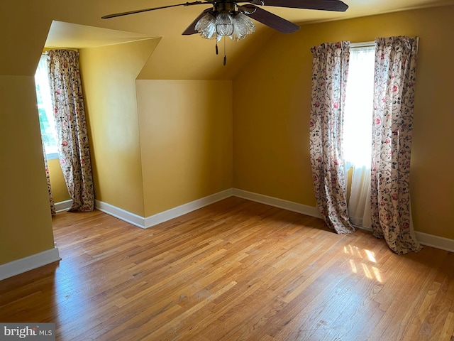 bonus room with baseboards, a ceiling fan, wood finished floors, and lofted ceiling