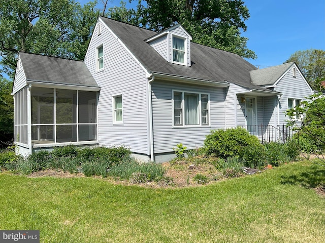 view of property exterior with a lawn and a sunroom