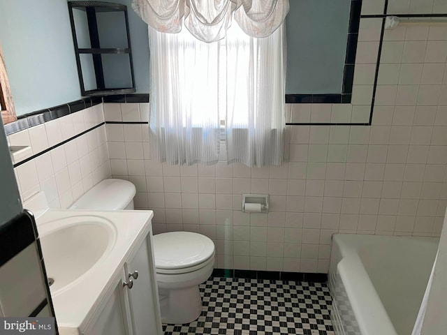 full bathroom featuring tile walls, vanity, and toilet