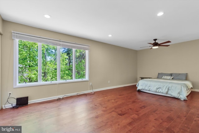 bedroom with baseboards, recessed lighting, and wood finished floors