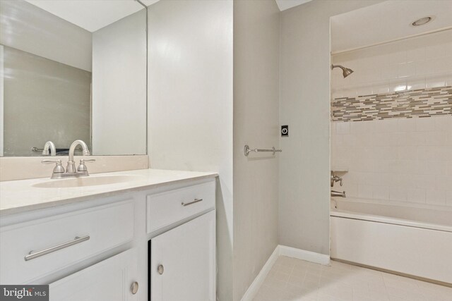 bathroom featuring vanity, baseboards, tile patterned flooring, and bathing tub / shower combination