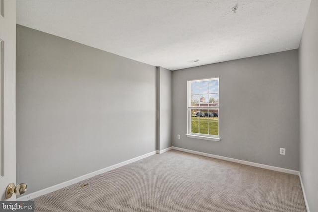 carpeted spare room with baseboards