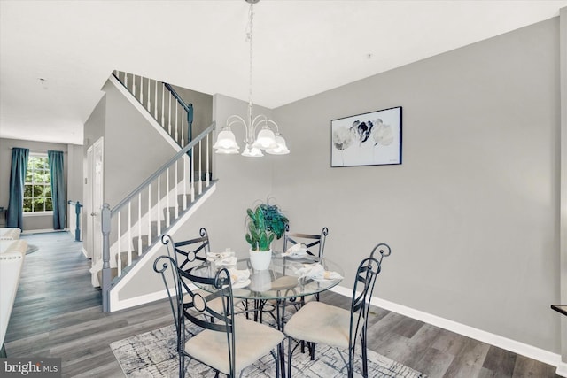 dining room featuring baseboards, stairs, and wood finished floors