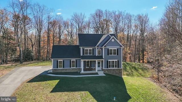 12815 Breyer Pl, Hughesville, MD 20637 - view of front facade featuring covered porch, a front lawn, and stone siding