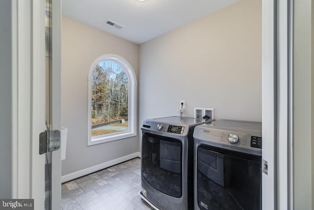 12815 Breyer Pl, Hughesville, MD 20637 - washroom featuring laundry area, stone finish flooring, washing machine and clothes dryer, visible vents, and baseboards