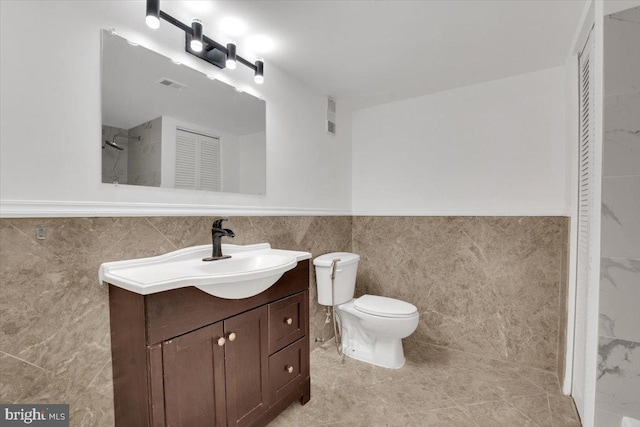 3709 S George Mason Dr Unit 1109E, Falls Church, VA 22041 - bathroom with visible vents, wainscoting, tile walls, and vanity