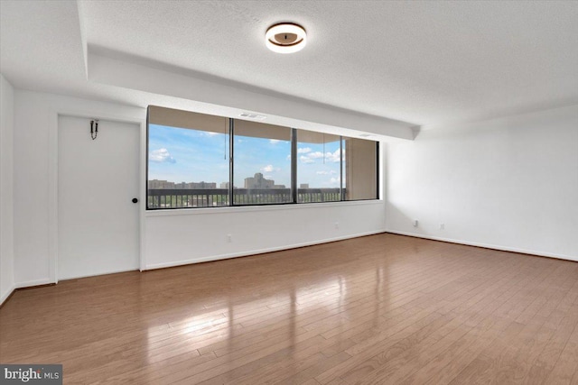 3709 S George Mason Dr Unit 1109E, Falls Church, VA 22041 - spare room with baseboards, a textured ceiling, visible vents, and wood finished floors