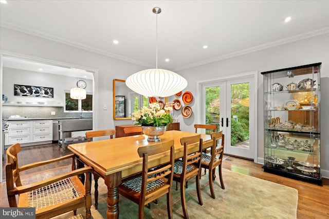 2871 Audubon Ter NW, Washington, DC 20008 - dining area with recessed lighting, light wood finished floors, french doors, and crown molding