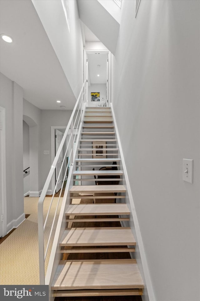 2871 Audubon Ter NW, Washington, DC 20008 - staircase featuring carpet flooring, baseboards, arched walkways, and recessed lighting