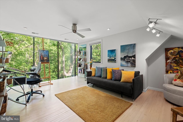 2871 Audubon Ter NW, Washington, DC 20008 - living room featuring expansive windows, wood finished floors, visible vents, vaulted ceiling, and ceiling fan