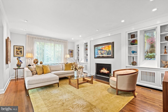 2871 Audubon Ter NW, Washington, DC 20008 - living area featuring hardwood / wood-style floors, built in features, visible vents, and a lit fireplace