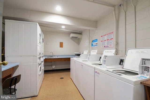4555 Macarthur Blvd NW Unit 202, Washington, DC 20007 - community laundry with washer and clothes dryer, stacked washer / drying machine, concrete block wall, and a wall unit AC