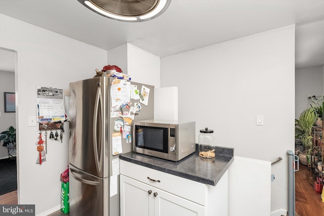 150 Elton Ave, Hamilton, NJ 08620 - kitchen with dark countertops, wood finished floors, baseboards, white cabinets, and stainless steel appliances