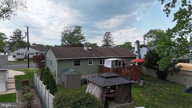 150 Elton Ave, Hamilton, NJ 08620 - back of house with an outdoor structure, a deck, a fenced backyard, a storage shed, and a yard