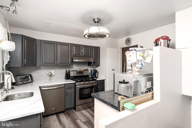 150 Elton Ave, Hamilton, NJ 08620 - kitchen with a sink, light wood-style floors, stainless steel appliances, tasteful backsplash, and under cabinet range hood