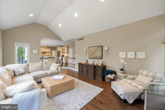 living room with visible vents, recessed lighting, wood finished floors, and high vaulted ceiling