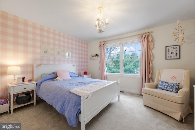 carpeted bedroom featuring baseboards, wallpapered walls, and a chandelier