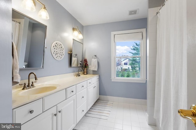 full bathroom featuring a sink, tile patterned flooring, double vanity, and visible vents