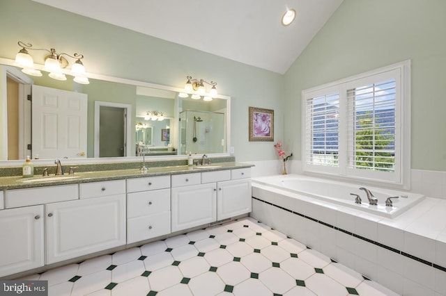 full bath featuring a garden tub, a sink, a stall shower, and double vanity