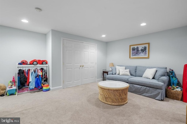 carpeted living room with recessed lighting and baseboards