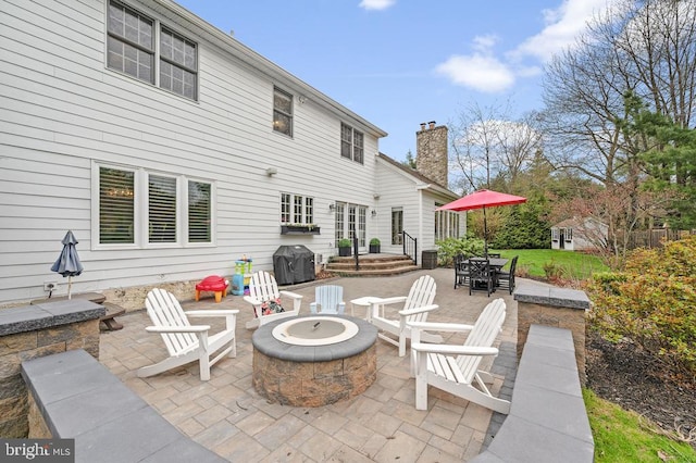 view of patio / terrace with an outdoor fire pit and area for grilling