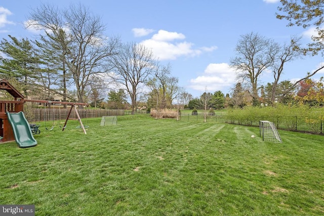 view of yard with a playground and a fenced backyard