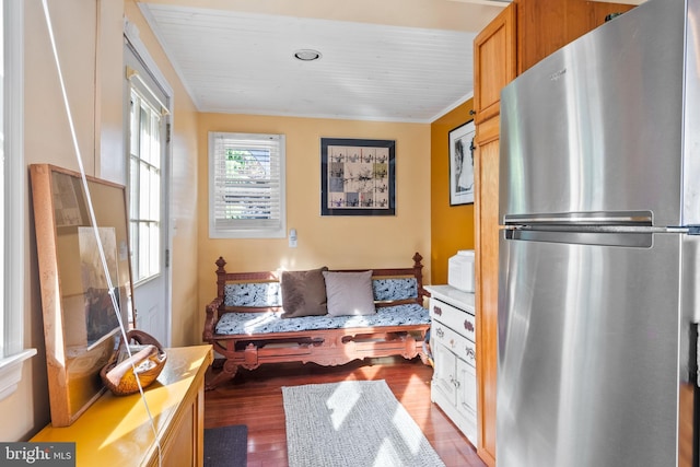 sitting room with wood ceiling, ornamental molding, and wood finished floors