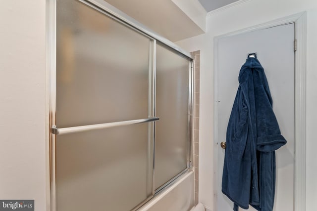 bathroom featuring shower / bath combination with glass door