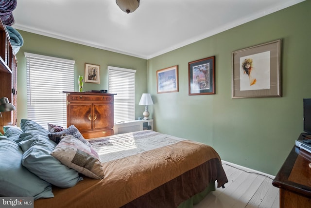 bedroom featuring baseboards and ornamental molding
