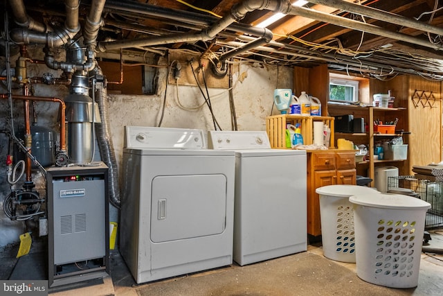 clothes washing area with separate washer and dryer and laundry area