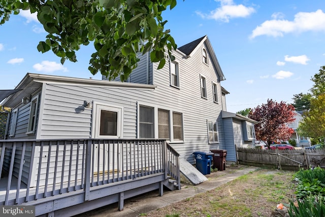 back of property featuring fence and a deck