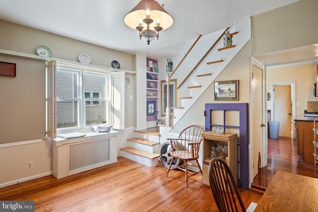 sitting room featuring hardwood / wood-style floors and stairway