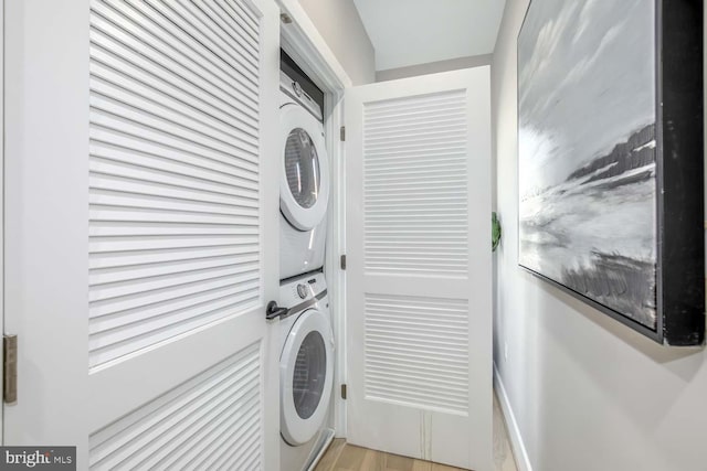 505 Kennedy St NW Unit 302, Washington, DC 20011 - washroom featuring laundry area, stacked washer and clothes dryer, and light wood-style flooring