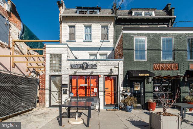 505 Kennedy St NW Unit 302, Washington, DC 20011 - rear view of house featuring mansard roof and brick siding