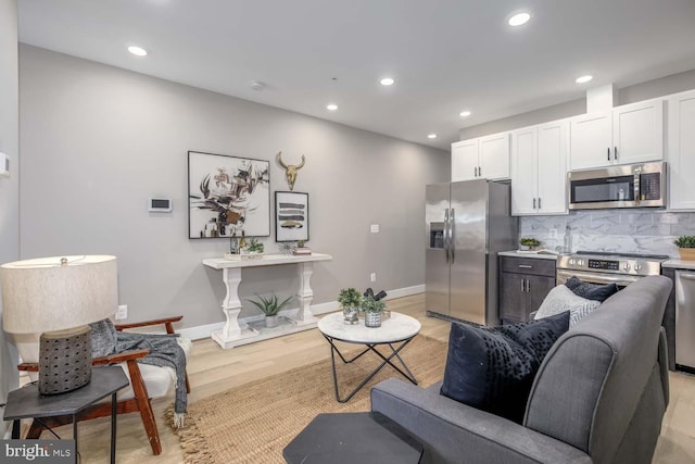 505 Kennedy St NW Unit 302, Washington, DC 20011 - living area with light wood finished floors, baseboards, and recessed lighting