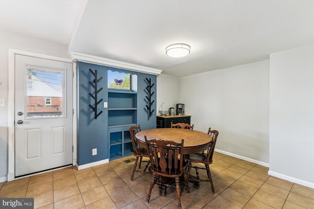 dining room with baseboards and light tile patterned floors