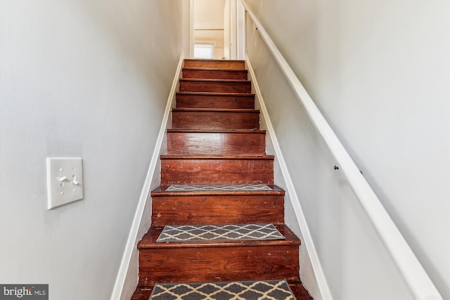 staircase featuring wood finished floors