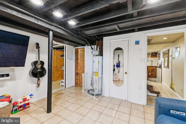 finished basement with light tile patterned floors and water heater