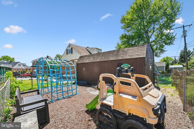 exterior space featuring an outbuilding, a fenced backyard, and a storage unit
