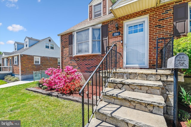 property entrance with brick siding