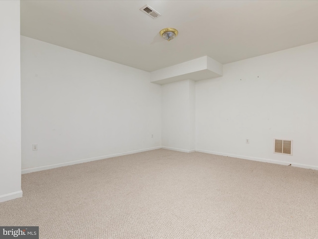 empty room with visible vents, baseboards, and carpet floors