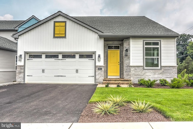 4324 Heather Ln Unit 5, Columbia, PA 17512 - view of front of house featuring a garage, a front lawn, aphalt driveway, stone siding, and a shingled roof