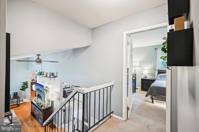 corridor featuring an upstairs landing, carpet, and baseboards