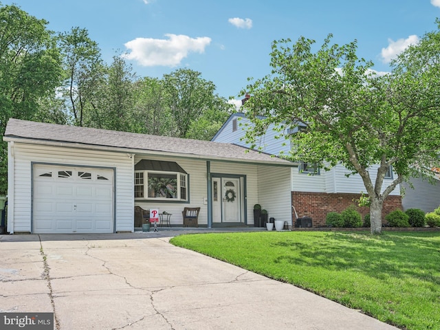 single story home featuring an attached garage, a front lawn, driveway, and covered porch